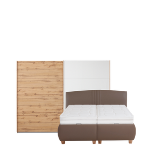 Braunes Boxspringbett vor weißem Schrank mit Holzdetails.