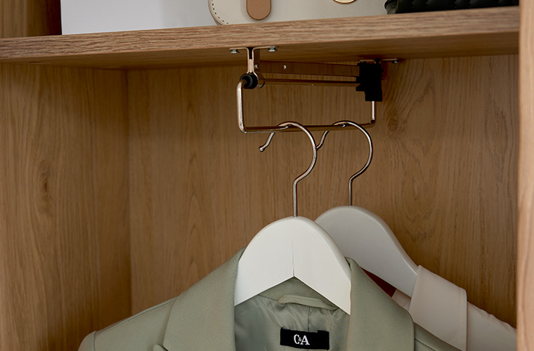 Innenansicht eines Garderobenschranks aus hellem Holz.