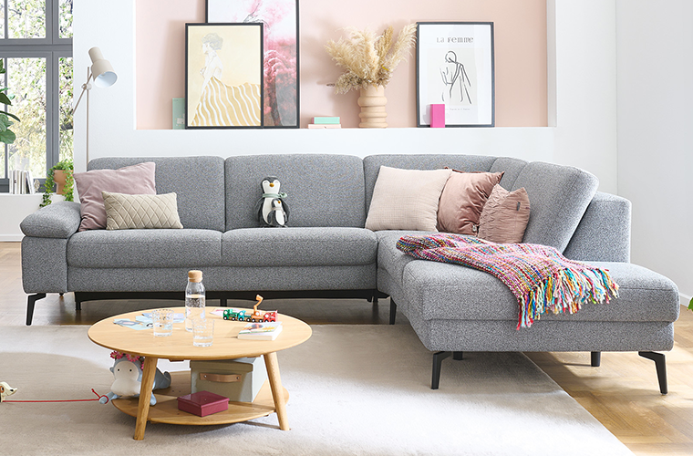 Garnitur „Hornbek“ in Grau mit Recamiere in einem hellen Wohnzimmer.