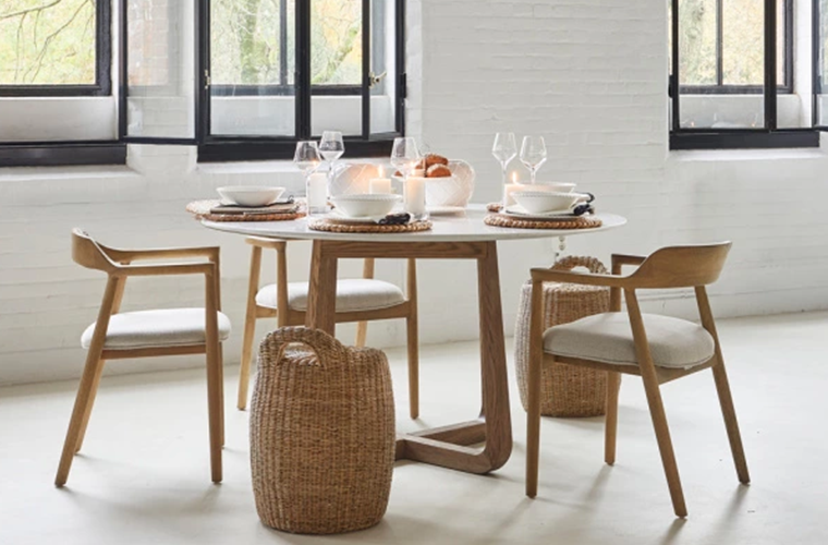 Rivièra Maison Esszimmerstühle aus hellem Holz mit gepolsterter Sitzfläche und Lehne.